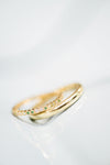 Wedding rings, one with white diamonds and emeralds, one plain 18k yellow gold.