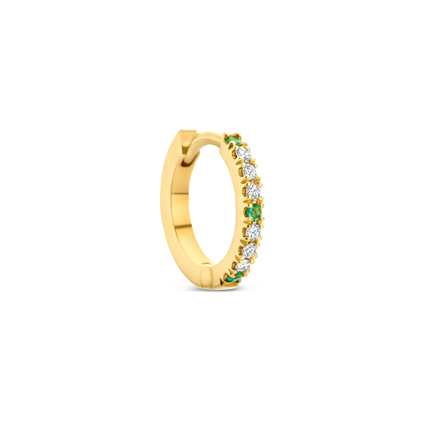 Gold hoop earring with emeralds and diamonds.