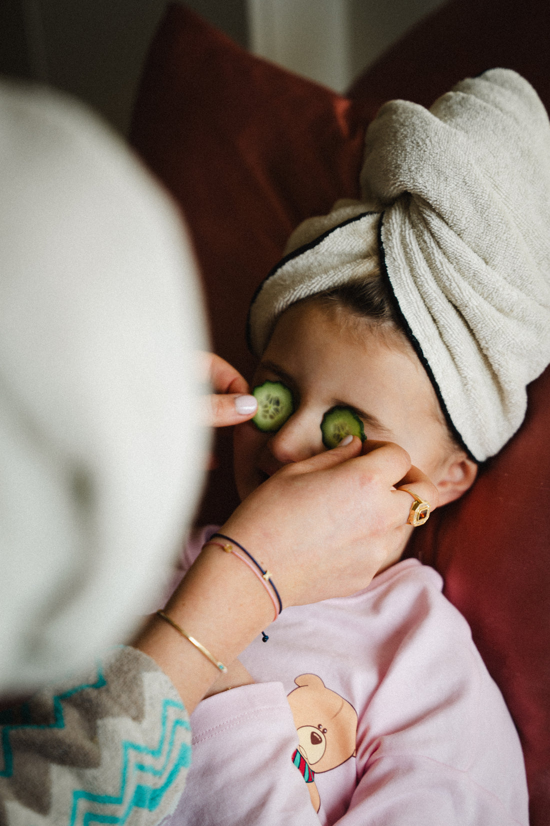 Art Deco Initial Bracelets worn on wrist during a spa treatment with towel on head