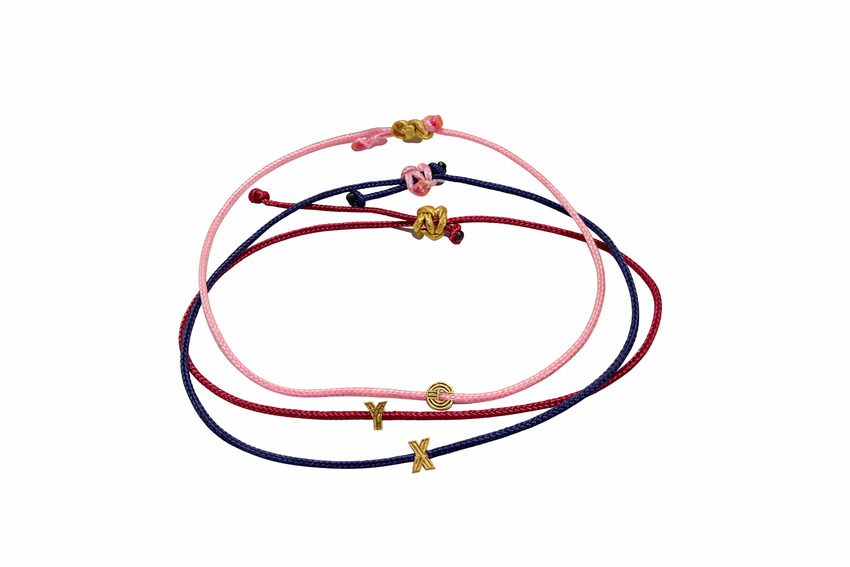 Set of three colorful bracelets with decorative charms