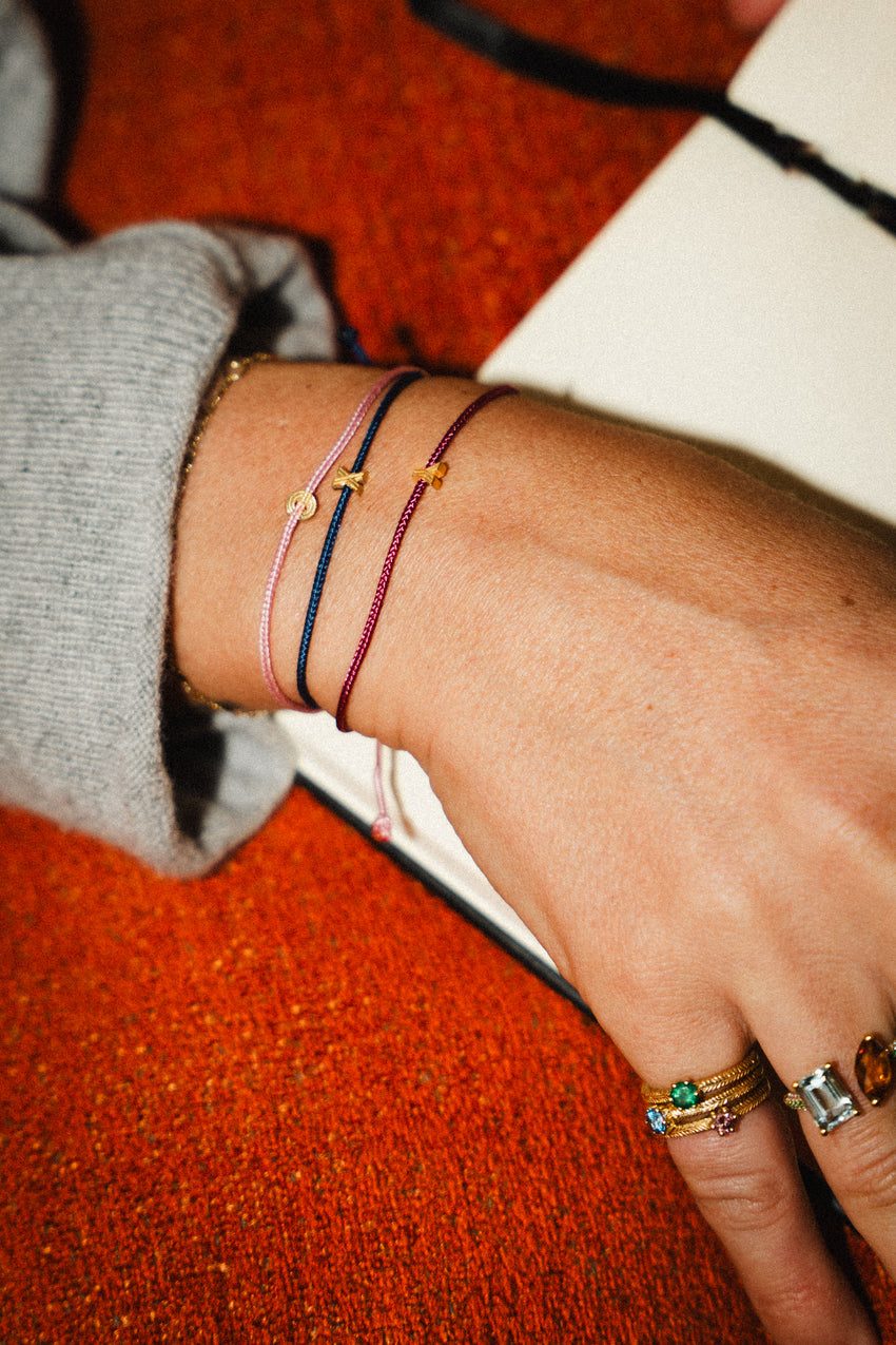 Art Deco Initial Bracelet with gold plating on an orange background