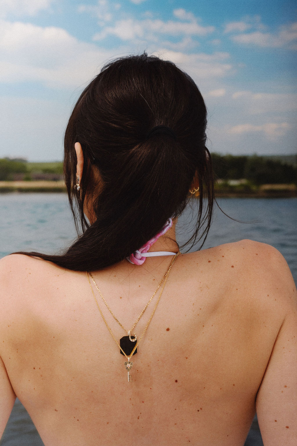 Fortune Charm, XL charm together on a wheat chain. The Key to Happiness Charm in pink on a long rope chain.