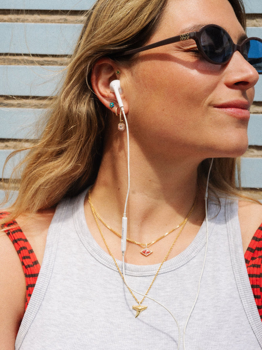 Shark tooth charm, Lozenge charm on chains. The white L hoop earring featuring a pink Rosalie earring charm.