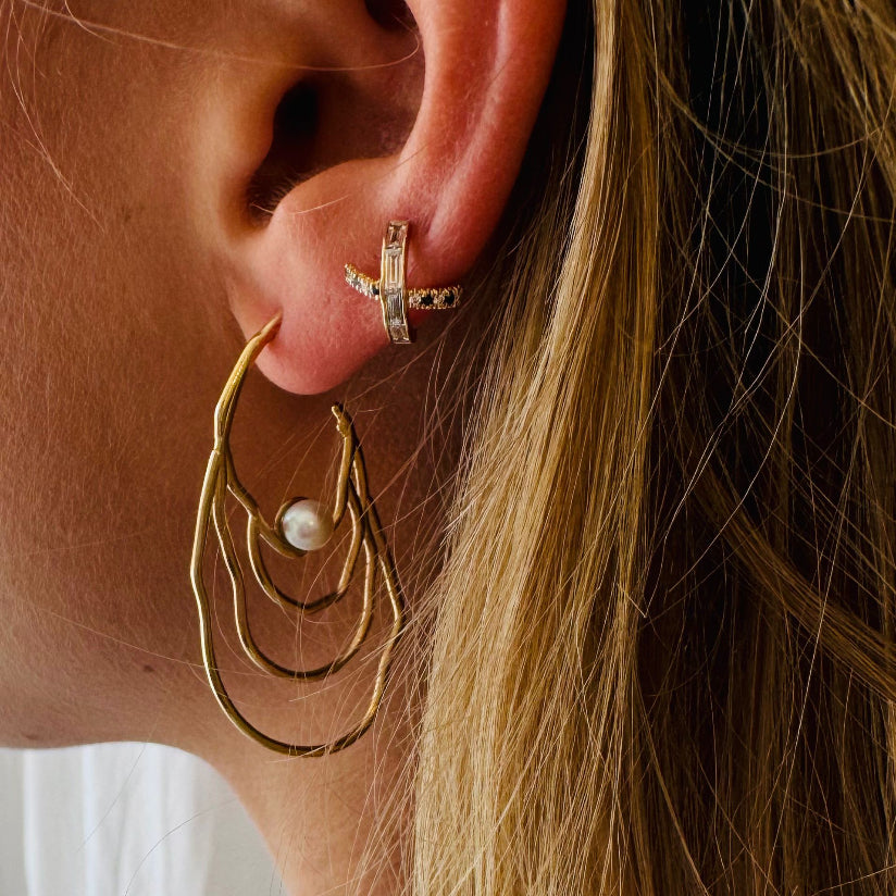 Cross ear studd pierced