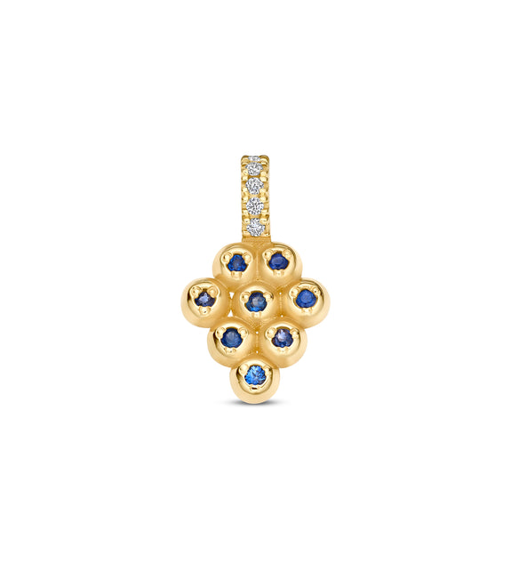 Gold pendant with blue stones and clear stones on a white background