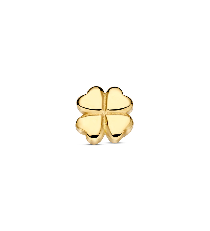 Gold four-leaf clover charm on a white background